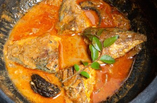 Kerala fish curry cooked in a clay pot. Coconuts milk copy